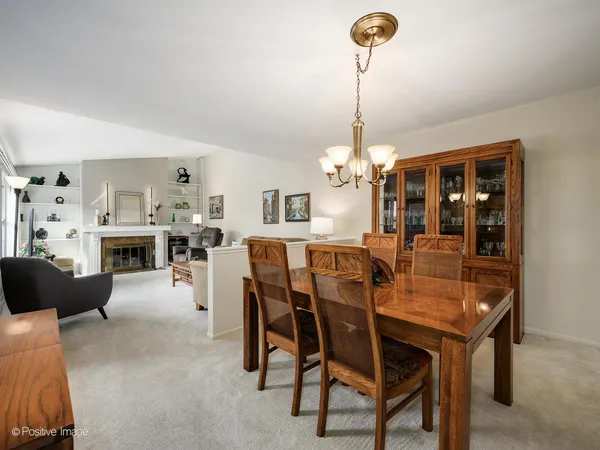 a view of a dining room with furniture and chandelier