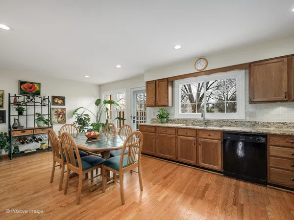 a kitchen with stainless steel appliances granite countertop a stove and a wooden cabinets