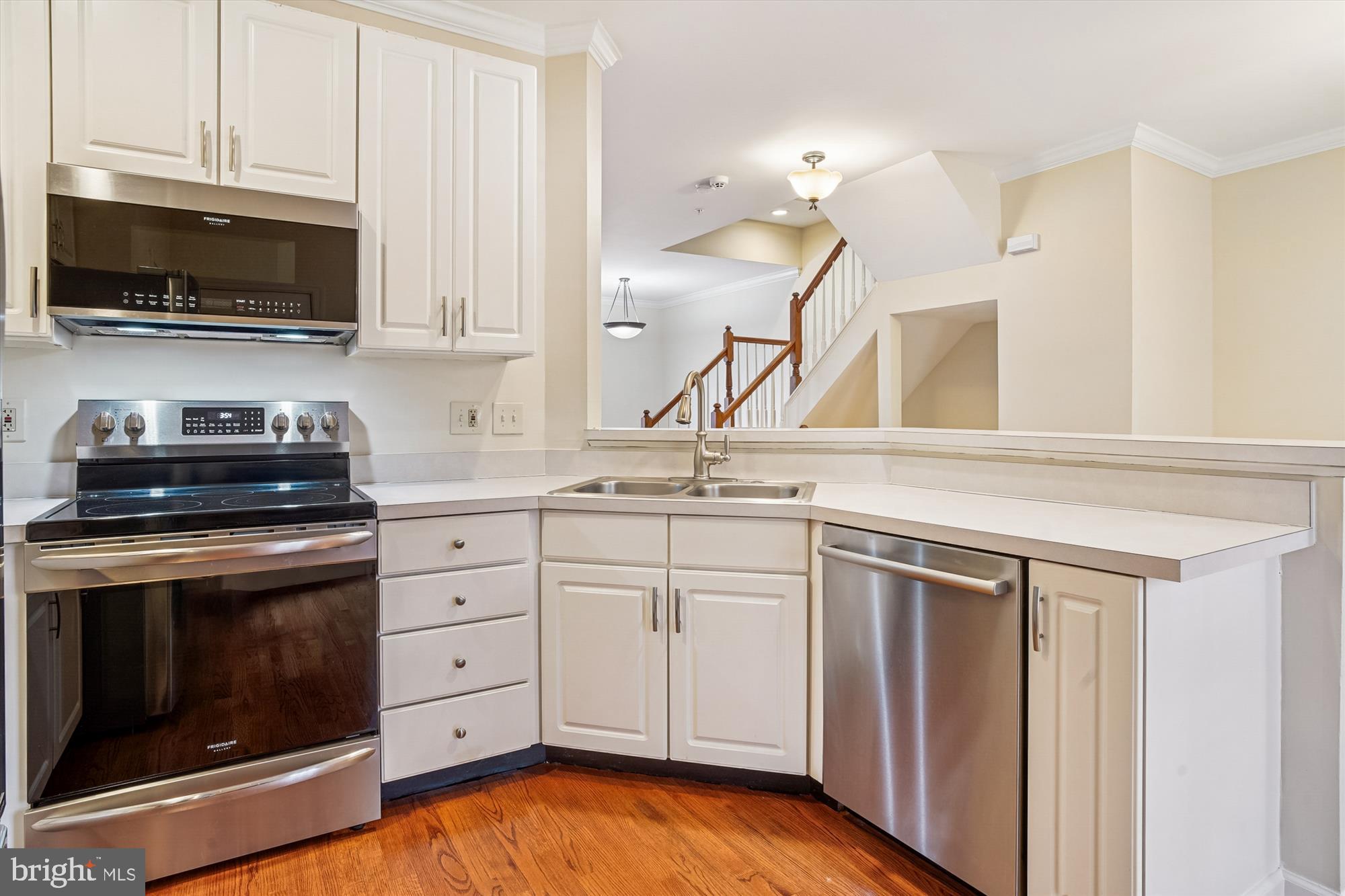 3232 Escapade Circle Riva, MD 21140 - Photo 10 of 38 a kitchen with white cabinets stainless steel appliances and sink