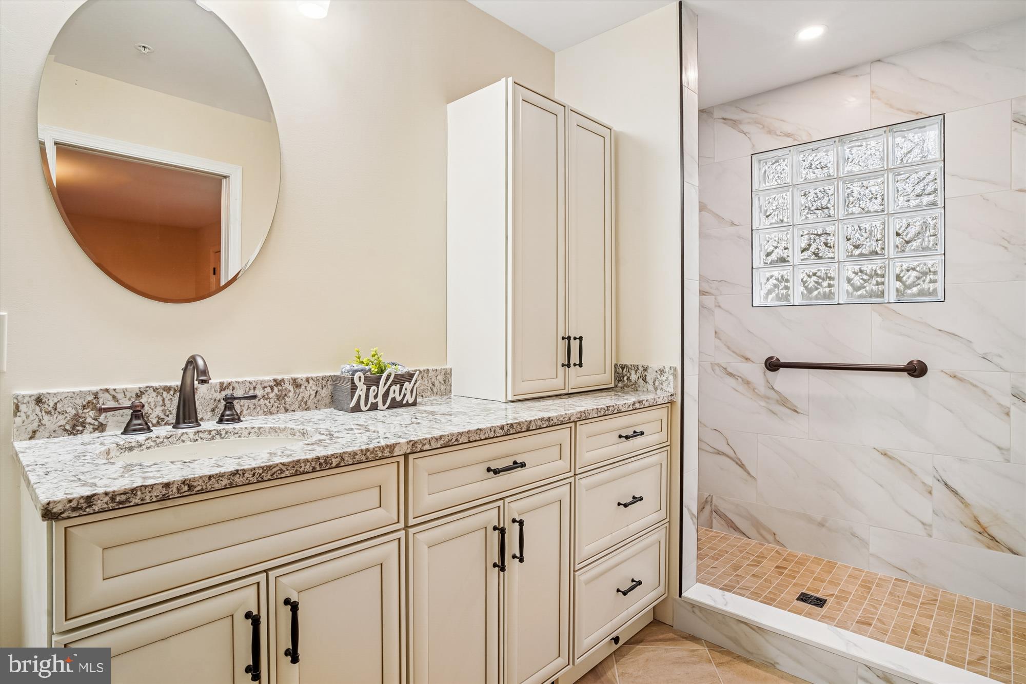 3232 Escapade Circle Riva, MD 21140 - Photo 16 of 38 a bathroom with a granite countertop sink a mirror a vanity and shower