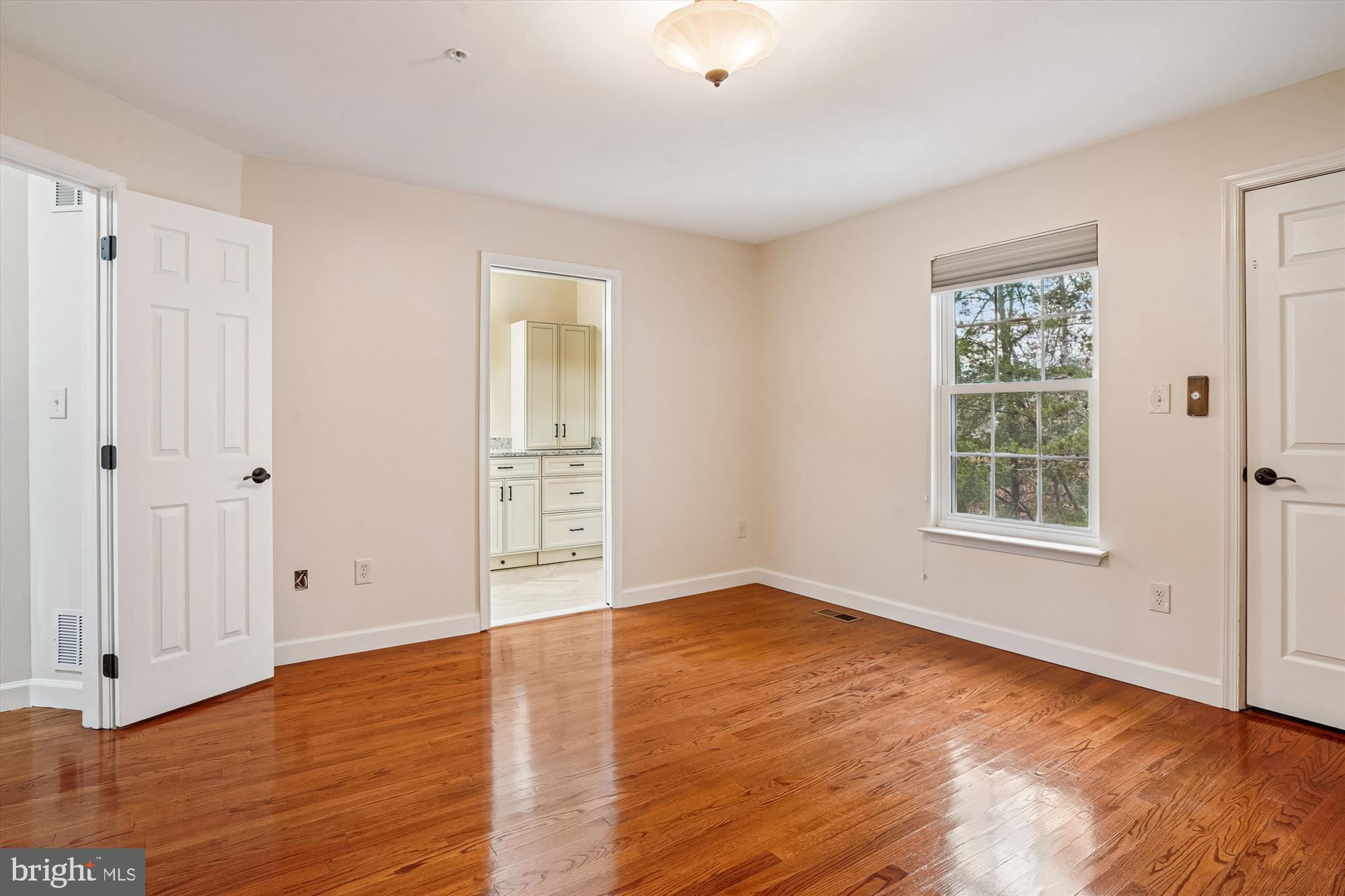 3232 Escapade Circle Riva, MD 21140 - Photo 17 of 38 a view of an empty room with wooden floor and a window