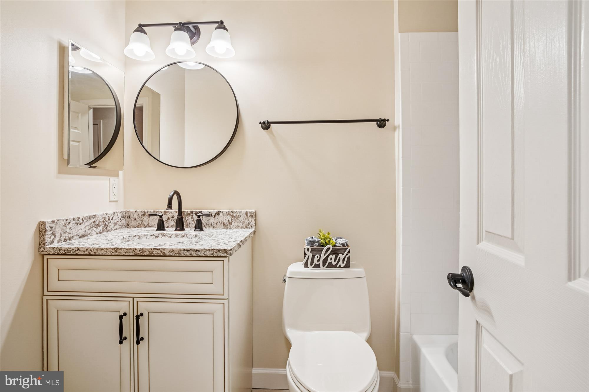 3232 Escapade Circle Riva, MD 21140 - Photo 21 of 38 a bathroom with a granite countertop toilet sink and mirror