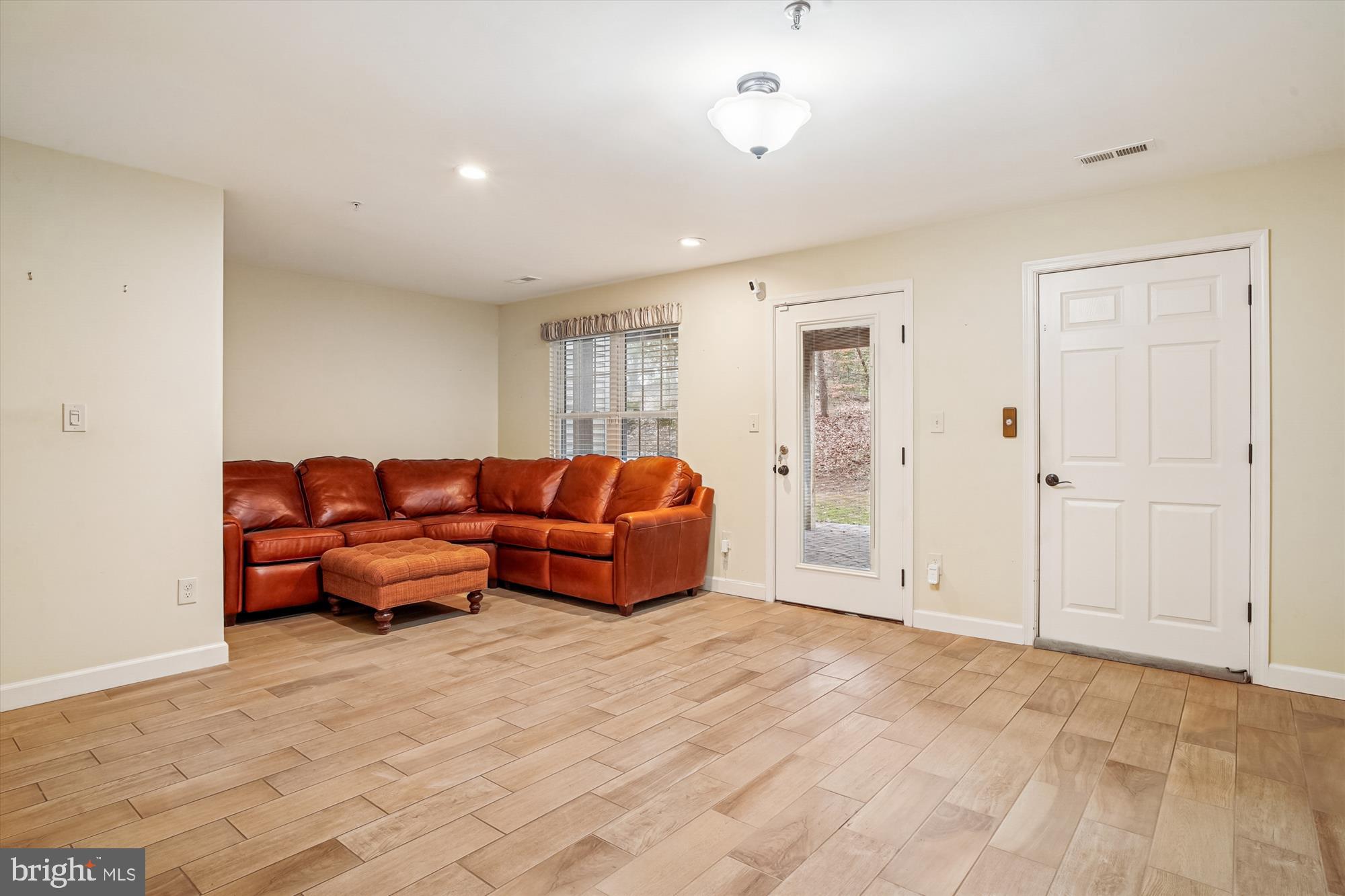 3232 Escapade Circle Riva, MD 21140 - Photo 27 of 38 a living room with furniture a lamp and a closet