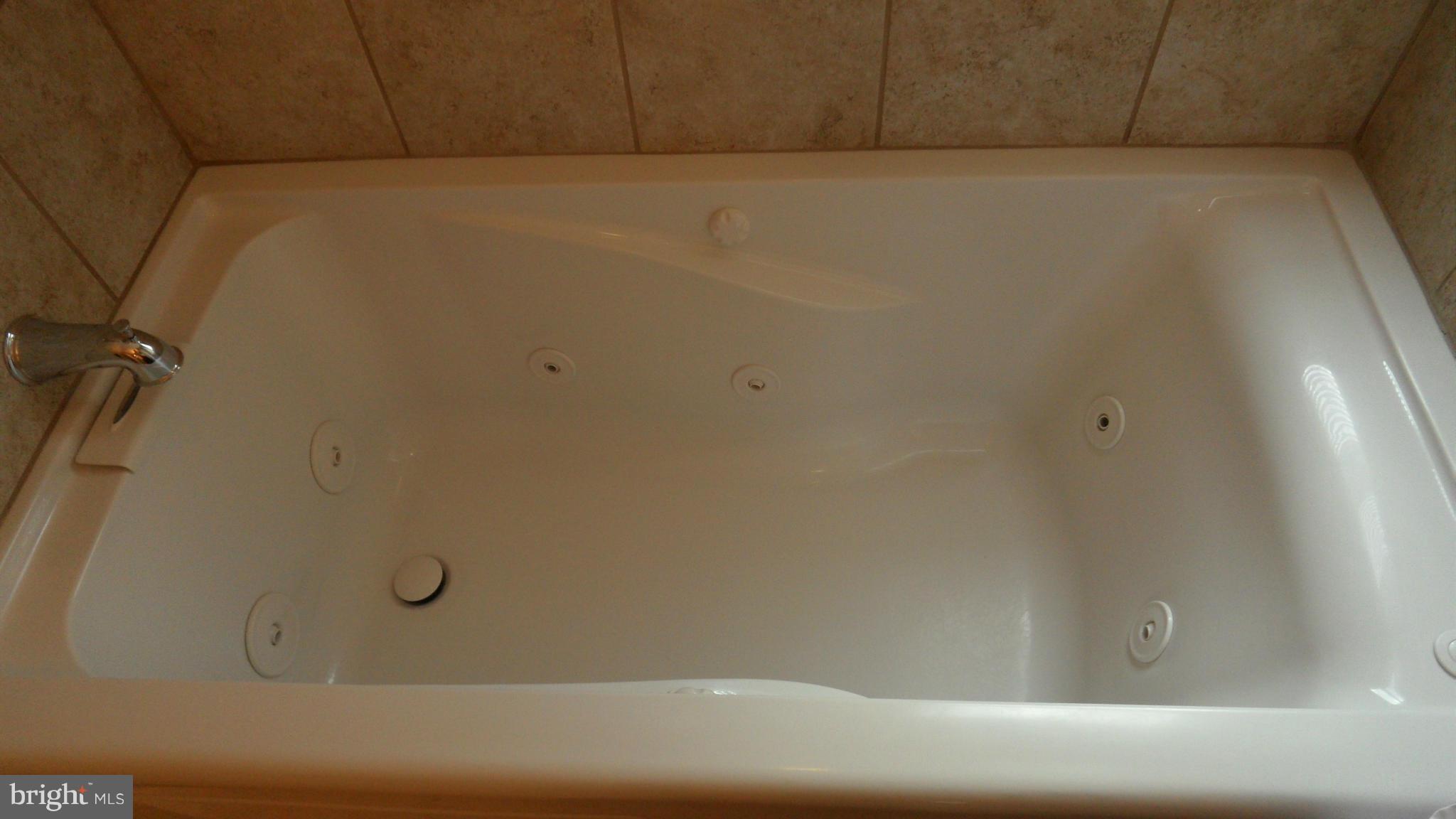 7413 Sudbrook Road Baltimore, MD 21208 - Photo 19 of 30 a bathroom with a bathtub