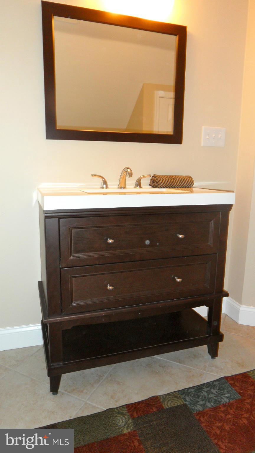 7413 Sudbrook Road Baltimore, MD 21208 - Photo 20 of 30 a bathroom with a sink vanity and mirror