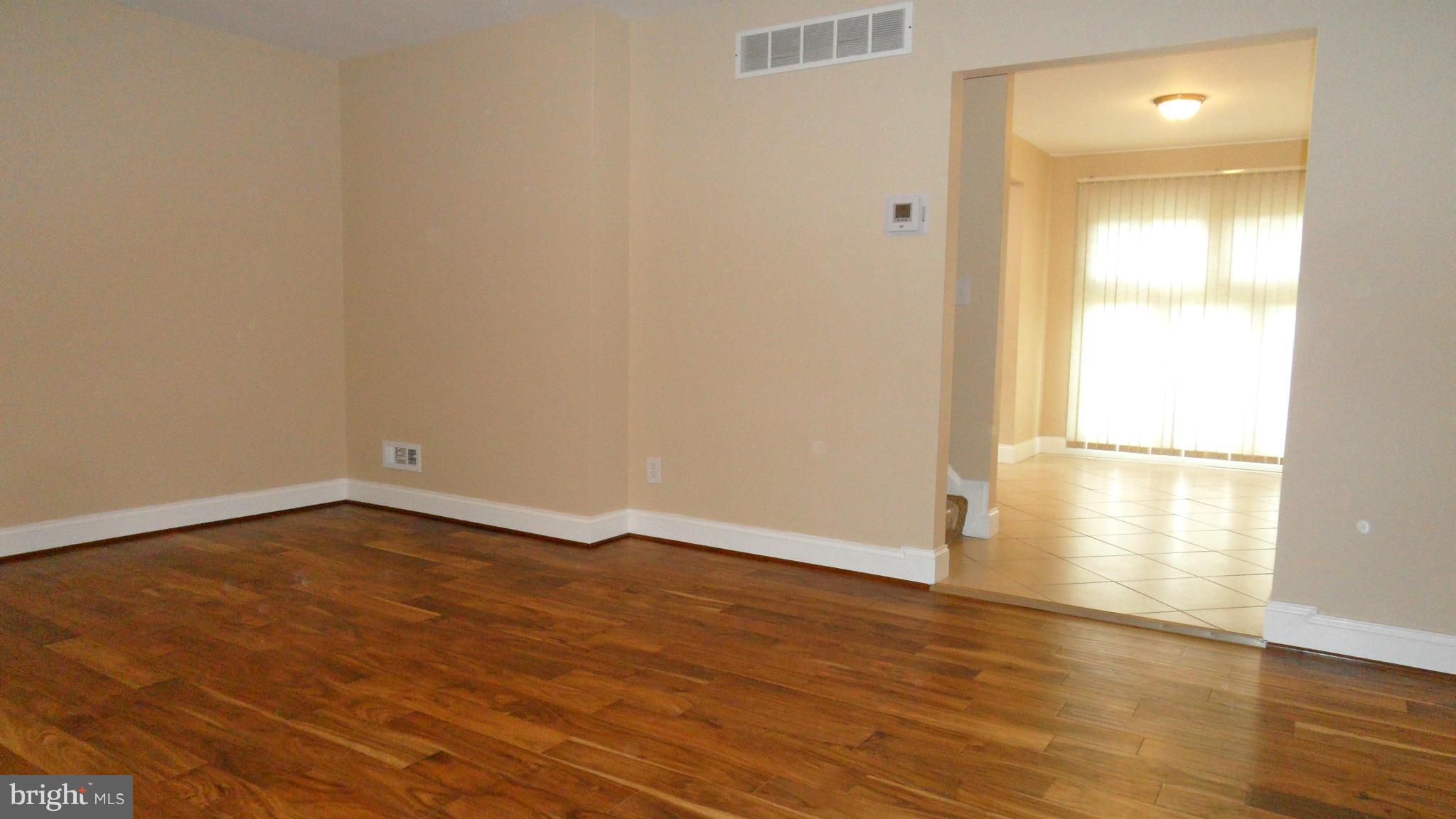 7413 Sudbrook Road Baltimore, MD 21208 - Photo 3 of 30 a view of an empty room and wooden floor