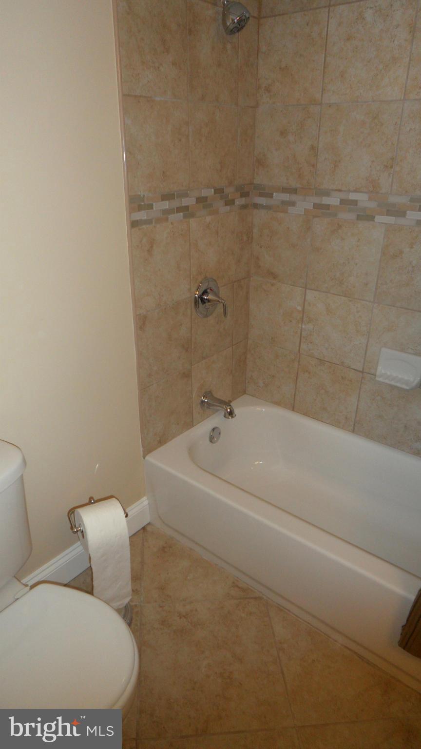 7413 Sudbrook Road Baltimore, MD 21208 - Photo 25 of 30 a bathroom with a toilet and bathtub