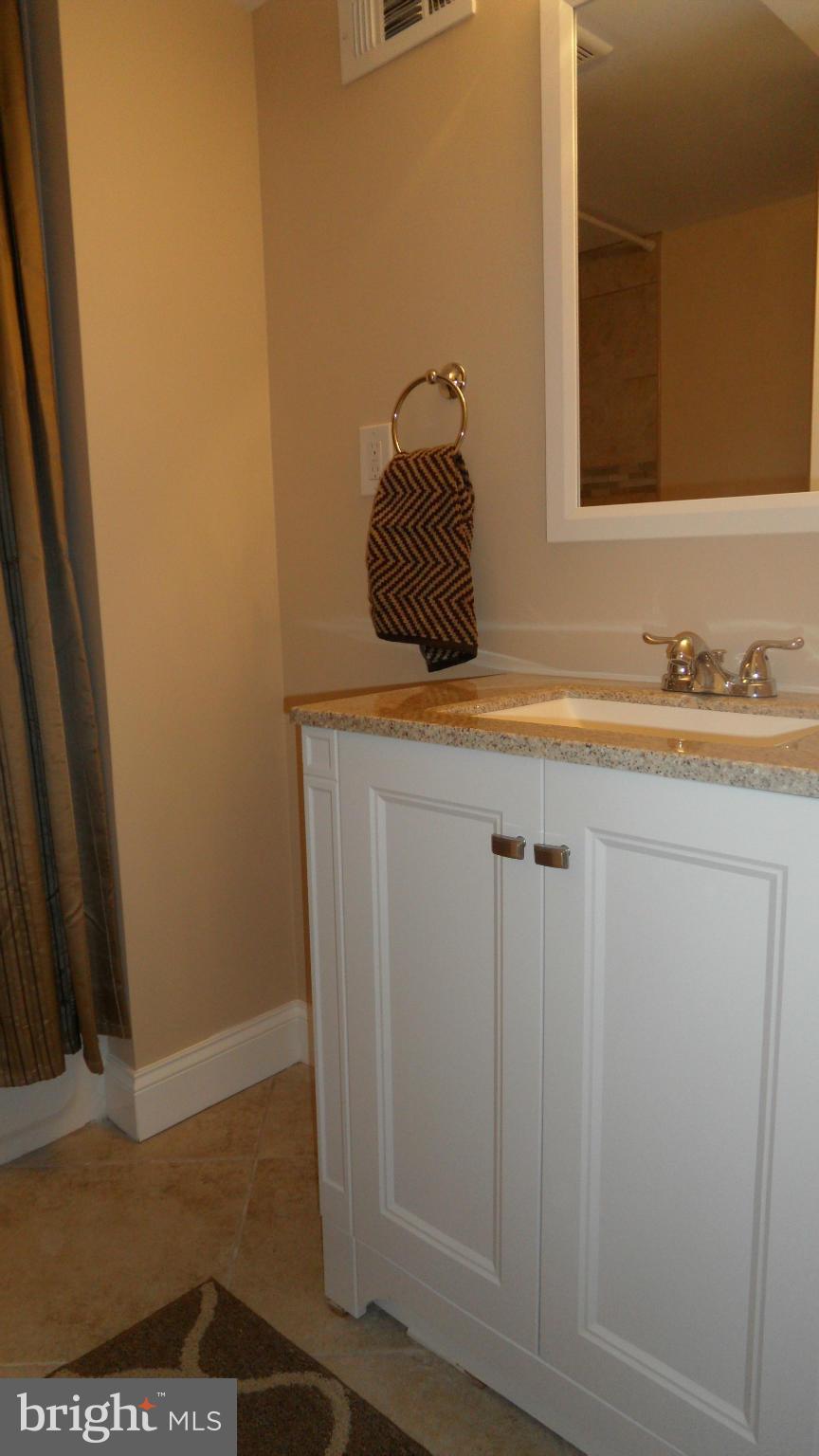 7413 Sudbrook Road Baltimore, MD 21208 - Photo 26 of 30 a bathroom with a sink and a mirror