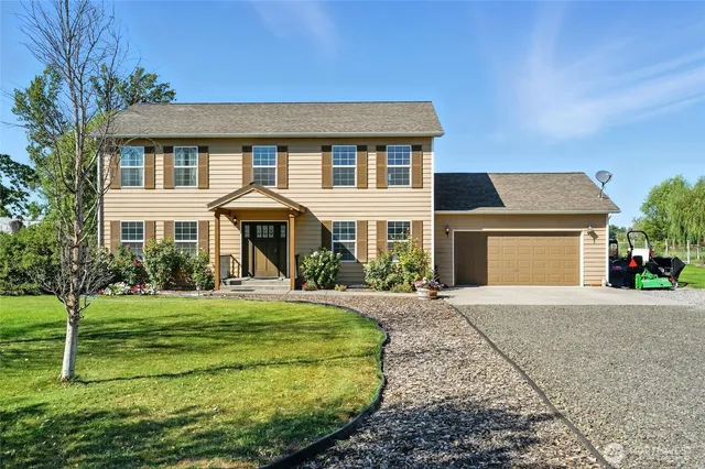 a front view of a house with a yard and garage