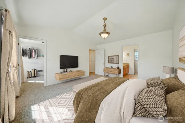 a bedroom with a bed and flat screen tv