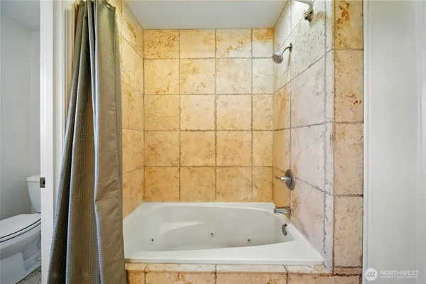 a white toilet sitting next to a window