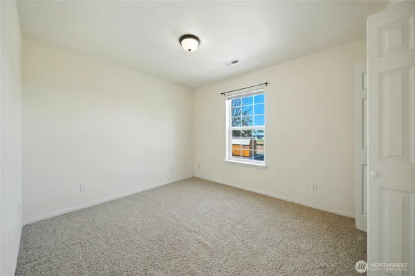 a spacious bathroom with a granite countertop sink toilet and shower