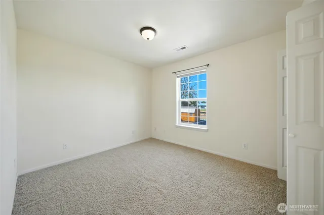 a spacious bathroom with a granite countertop sink toilet and shower