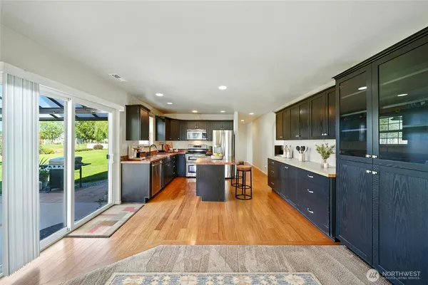 a large kitchen with lots of counter space a sink and stainless steel appliances