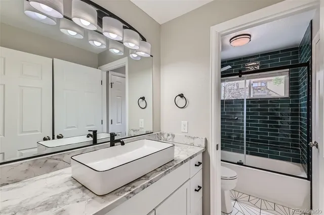 a bathroom with a sink vanity granite and a mirror