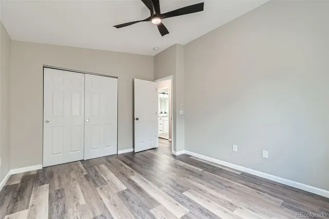 a view of a room with wooden floor and white walls