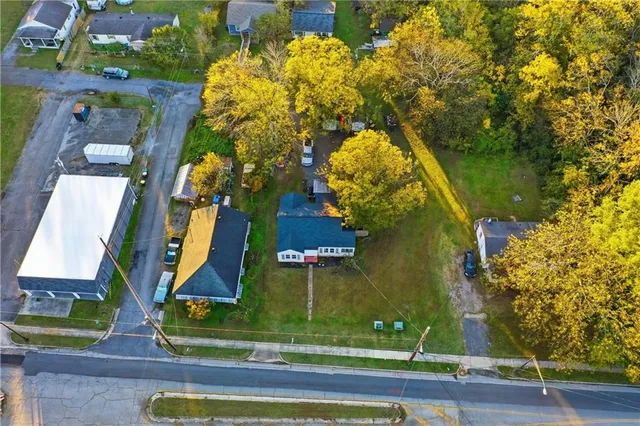 an aerial view of a residential apartment building with a yard and potted plants