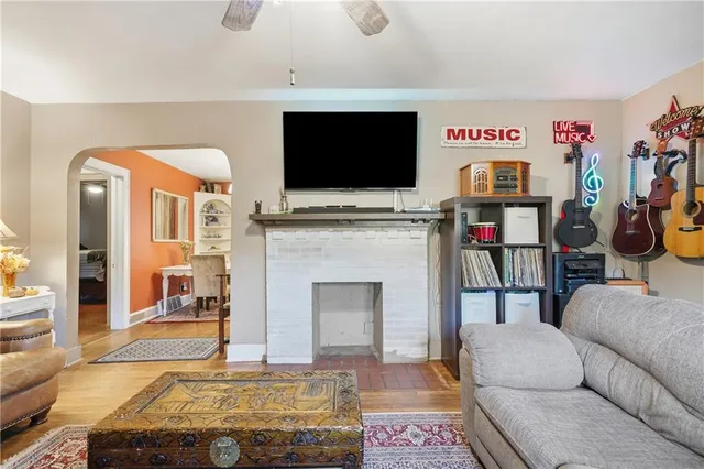 a living room with furniture a flat screen tv and a fireplace
