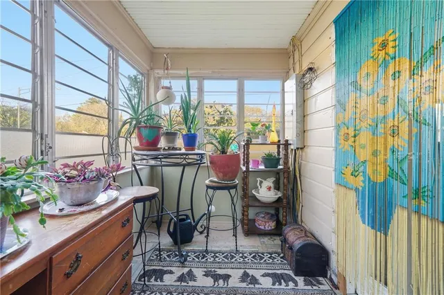 a view of a room with chairs and potted plants