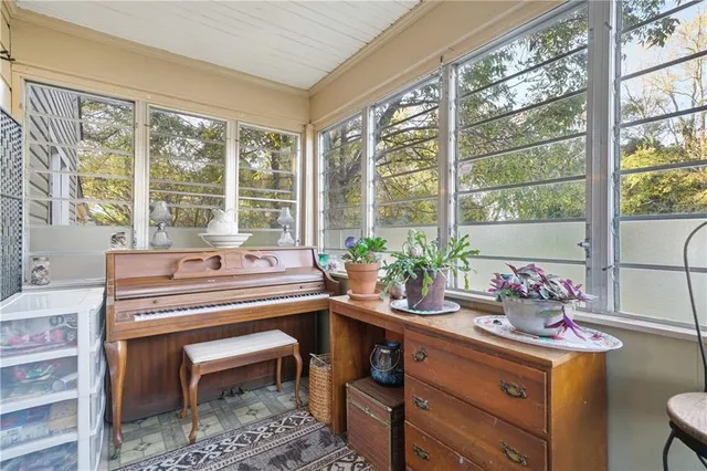 a kitchen with a sink and large windows