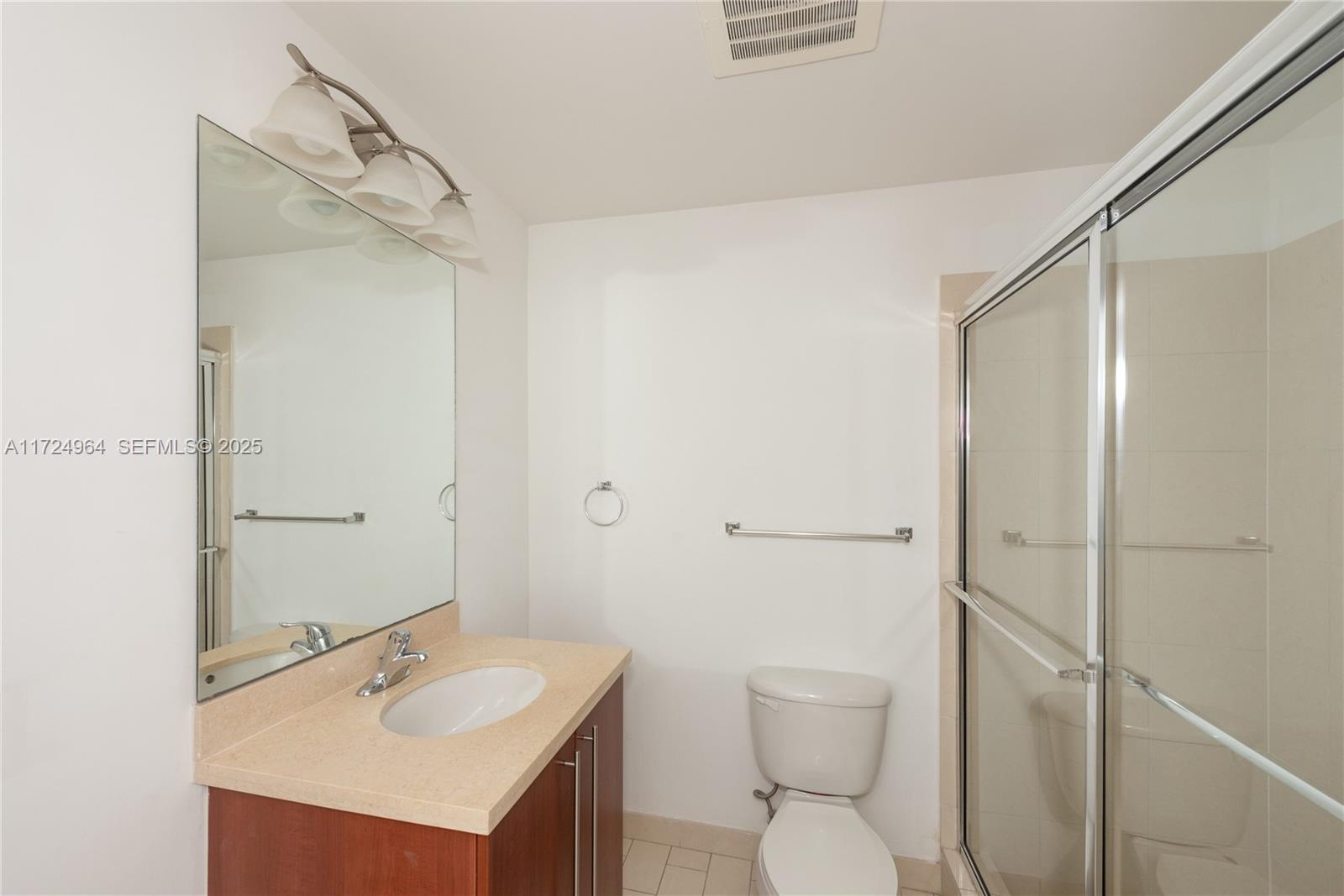 79 Southwest 12th Street, Unit 1107S Miami, FL 33130 - Photo 18 of 26 a bathroom with a sink a toilet and shower