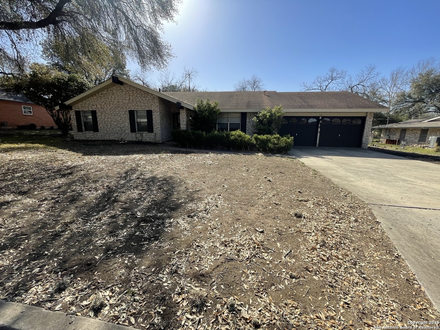 a front view of house with a garden