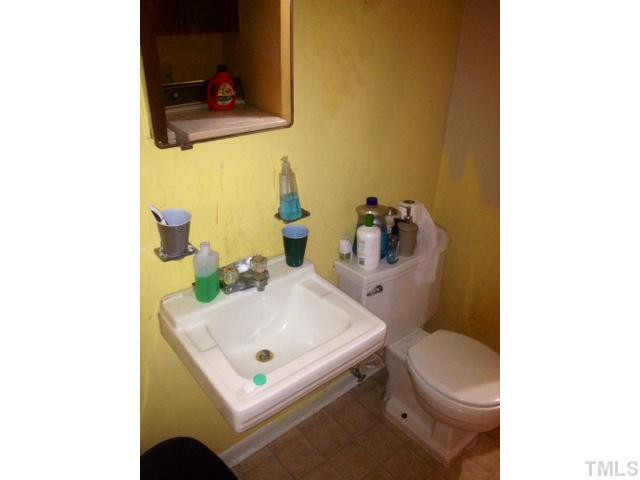 524 Cooper Road Raleigh, NC 27610 - Photo 5 of 12 a bathroom with a sink and a toilet