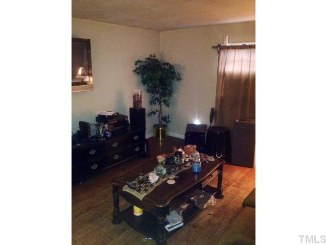524 Cooper Road Raleigh, NC 27610 - Photo 10 of 12 a living room with furniture and a potted plant