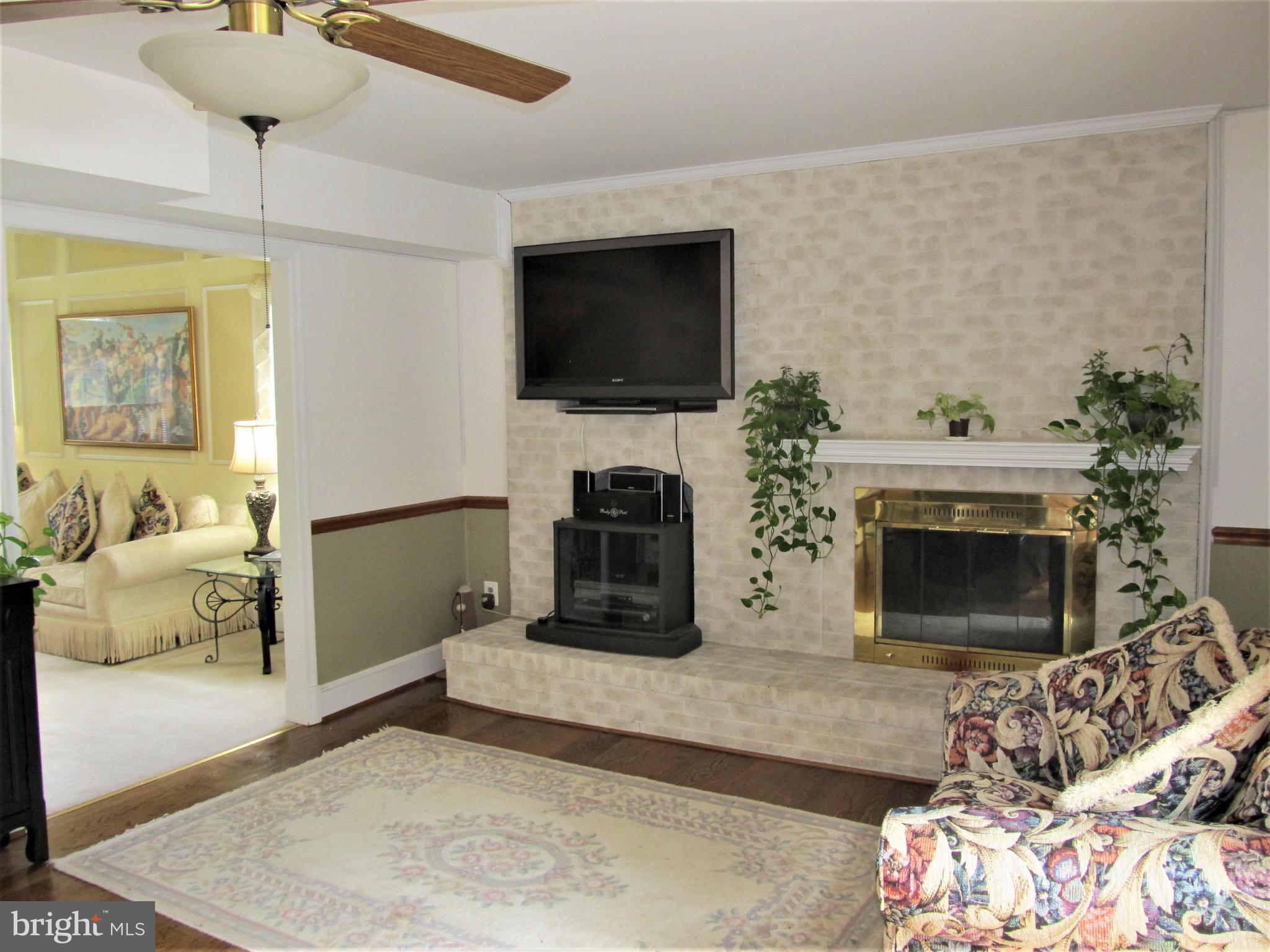 6224 Medora Road Linthicum, MD 21090 - Photo 8 of 29 a living room with furniture a flat screen tv and a fireplace