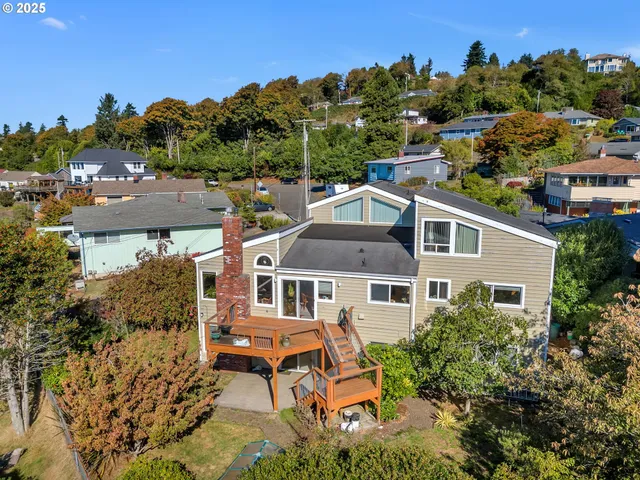 an aerial view of a house with a garden and mountain view