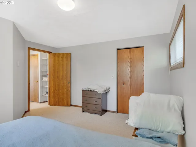 a bedroom with a bed and window