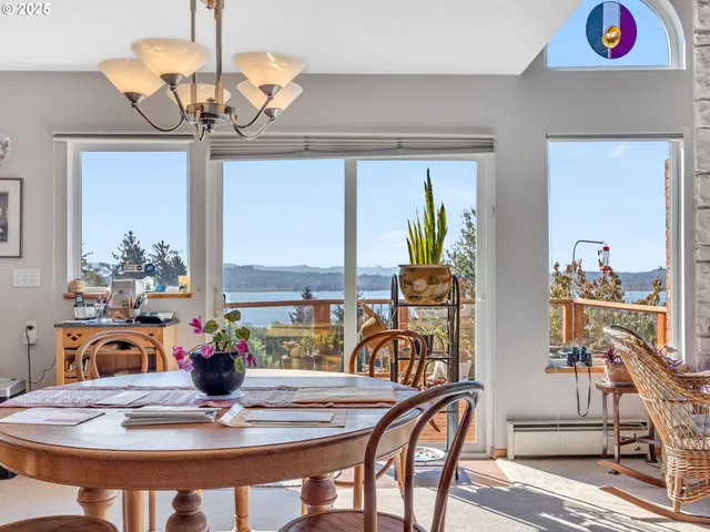 a view of a dining room with furniture a chandelier and wooden floor