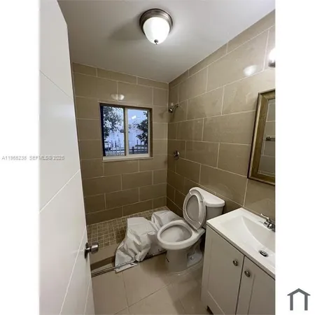 a bathroom with a toilet sink and shower