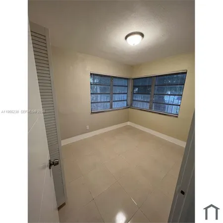 a view of an empty room with a fireplace