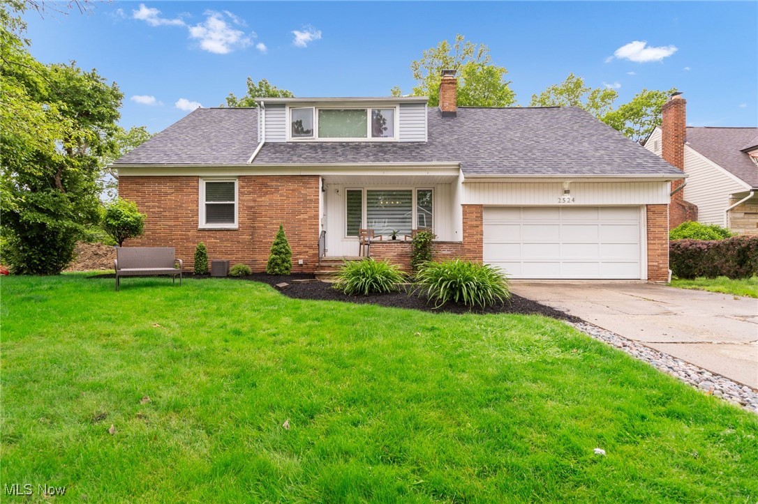 2524 Claver Road Cleveland, OH 44118 - Photo 1 of 50 View of front facade with a front yard, brick siding, concrete driveway, and a garage