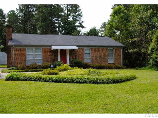 1326 Sedwick Road Durham, NC 27713 - Photo 1 of 19 a front view of a house with a garden