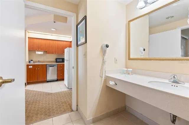 a bathroom with a sink vanity tub and shower