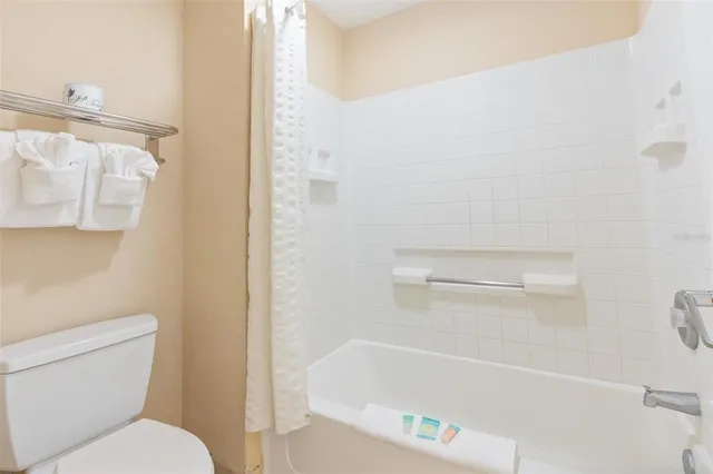 a kitchen with a sink a refrigerator and cabinets
