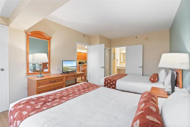 a bedroom with two beds and a window