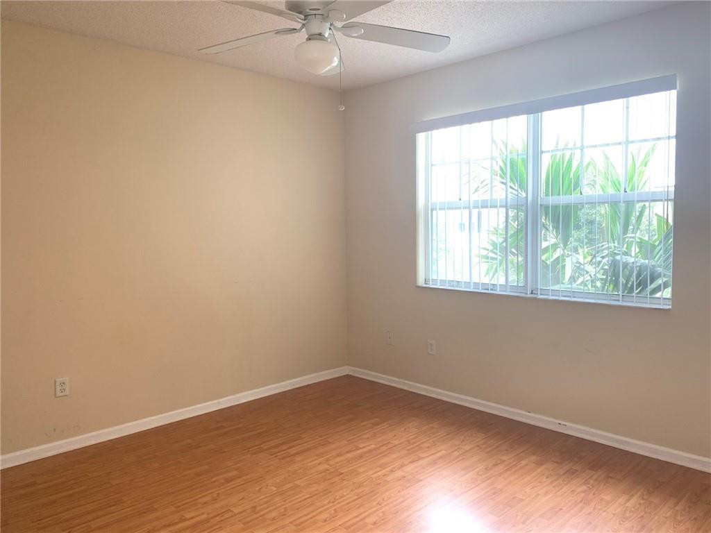 5980 West Sample Road, Unit 303 Coral Springs, FL 33067 - Photo 11 of 32 an empty room with a window
