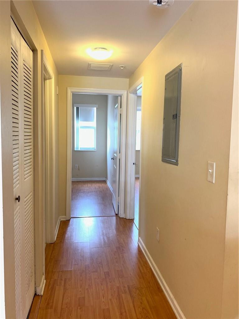 5980 West Sample Road, Unit 303 Coral Springs, FL 33067 - Photo 14 of 32 a view of a hallway with wooden floor