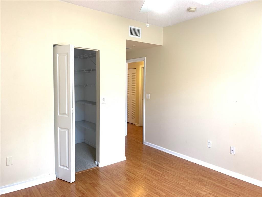 5980 West Sample Road, Unit 303 Coral Springs, FL 33067 - Photo 16 of 32 a view of hallway with wooden floor