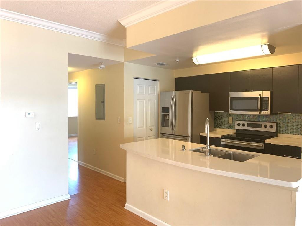 5980 West Sample Road, Unit 303 Coral Springs, FL 33067 - Photo 21 of 32 a view of a kitchen with a sink and refrigerator