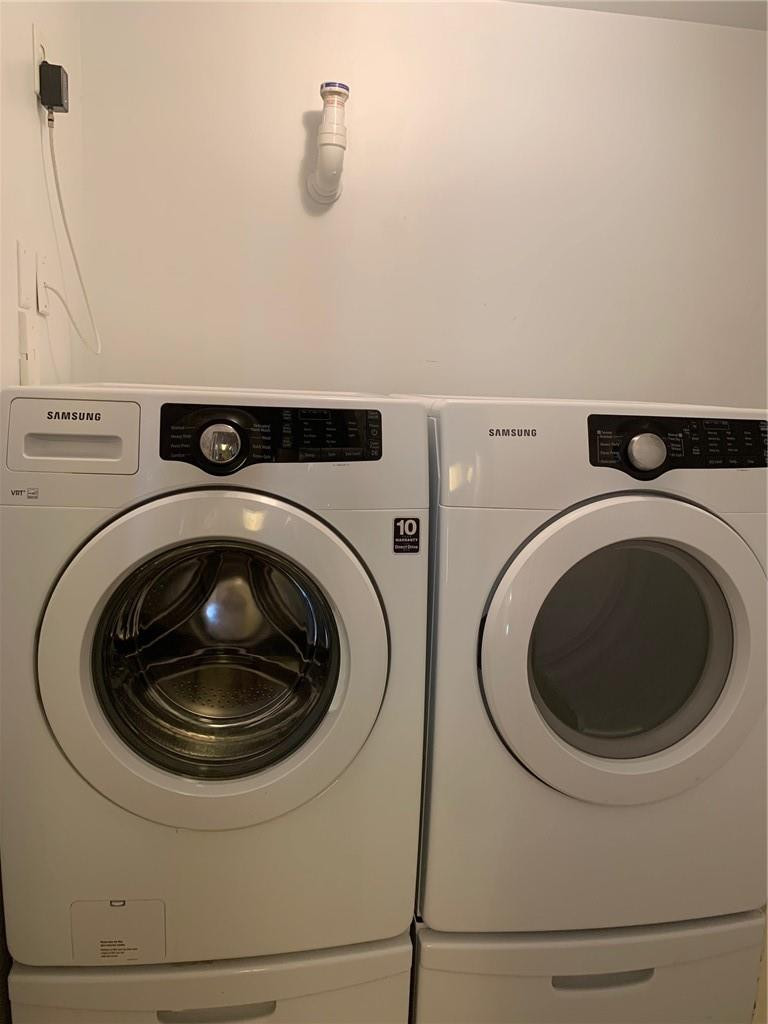 5980 West Sample Road, Unit 303 Coral Springs, FL 33067 - Photo 22 of 32 a utility room with dryer and washer