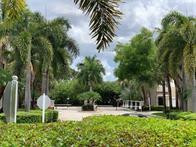 5980 West Sample Road, Unit 303 Coral Springs, FL 33067 - Photo 23 of 32 a view of a backyard with a garden