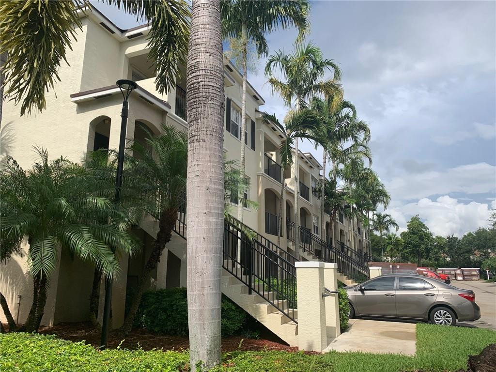 5980 West Sample Road, Unit 303 Coral Springs, FL 33067 - Photo 25 of 32 a view of multiple houses with a yard