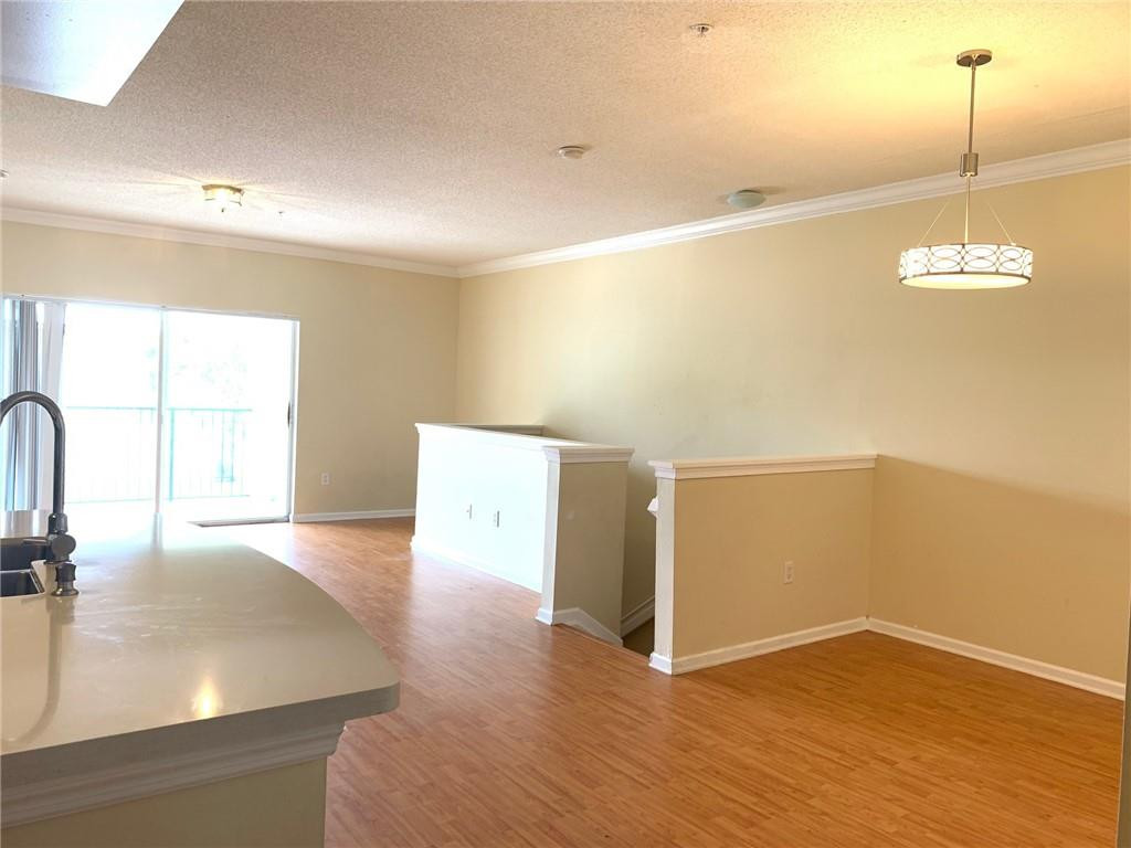 5980 West Sample Road, Unit 303 Coral Springs, FL 33067 - Photo 9 of 32 a view of a room with wooden floor