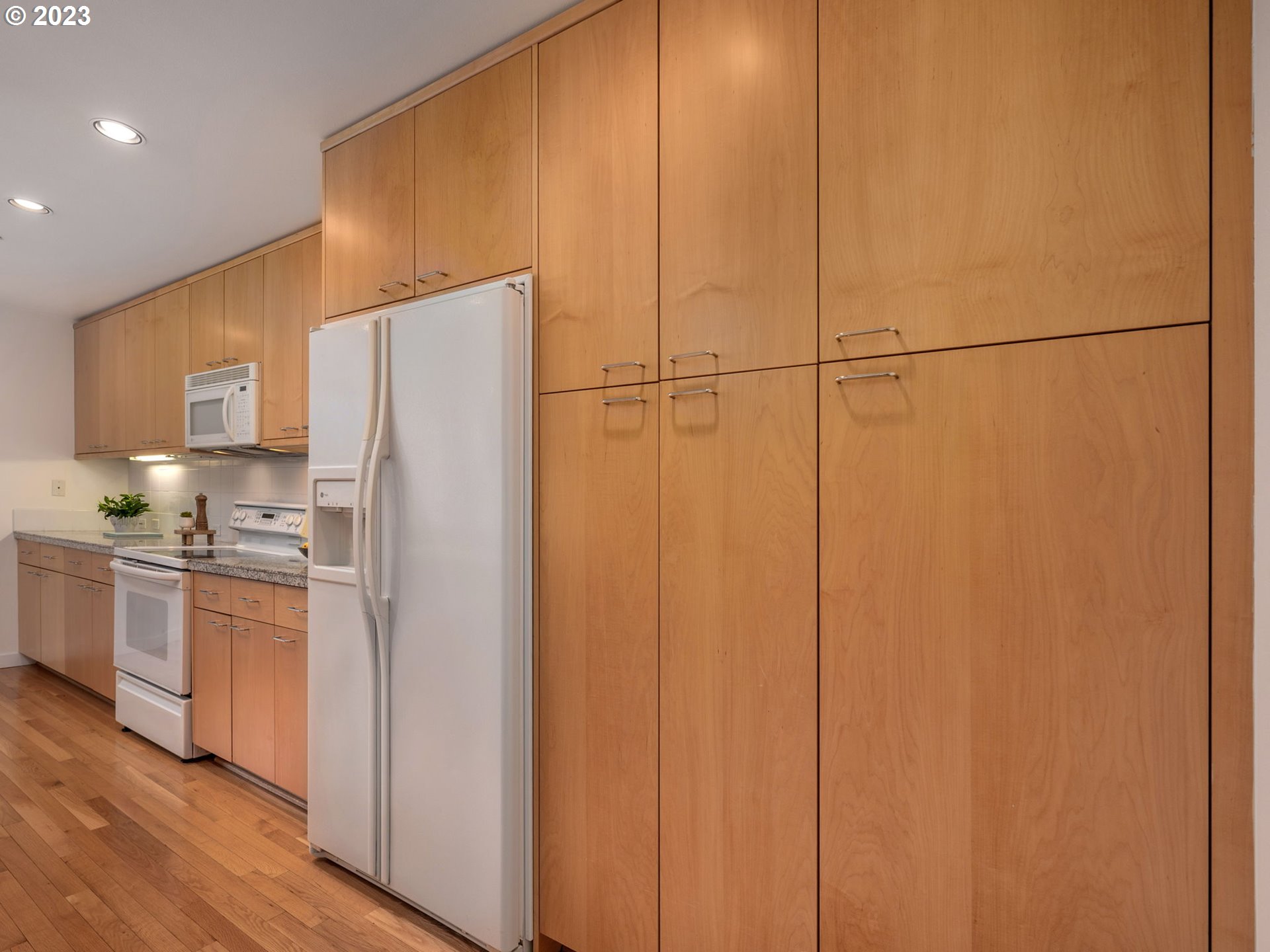 2445 Northwest Westover Road, Unit 314 Portland, OR 97210 - Photo 14 of 32 a kitchen with stainless steel appliances a refrigerator and a stove top oven