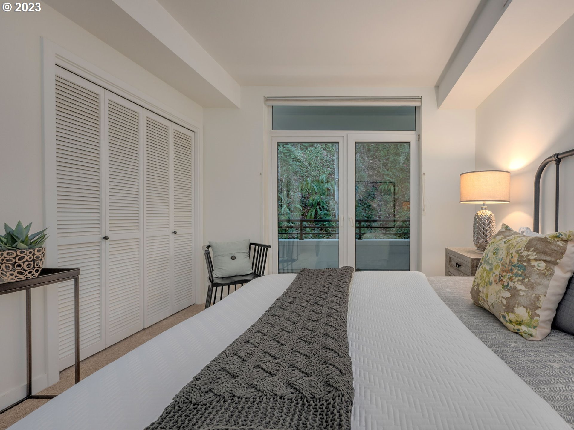 2445 Northwest Westover Road, Unit 314 Portland, OR 97210 - Photo 24 of 32 a bedroom with a bed and a large window