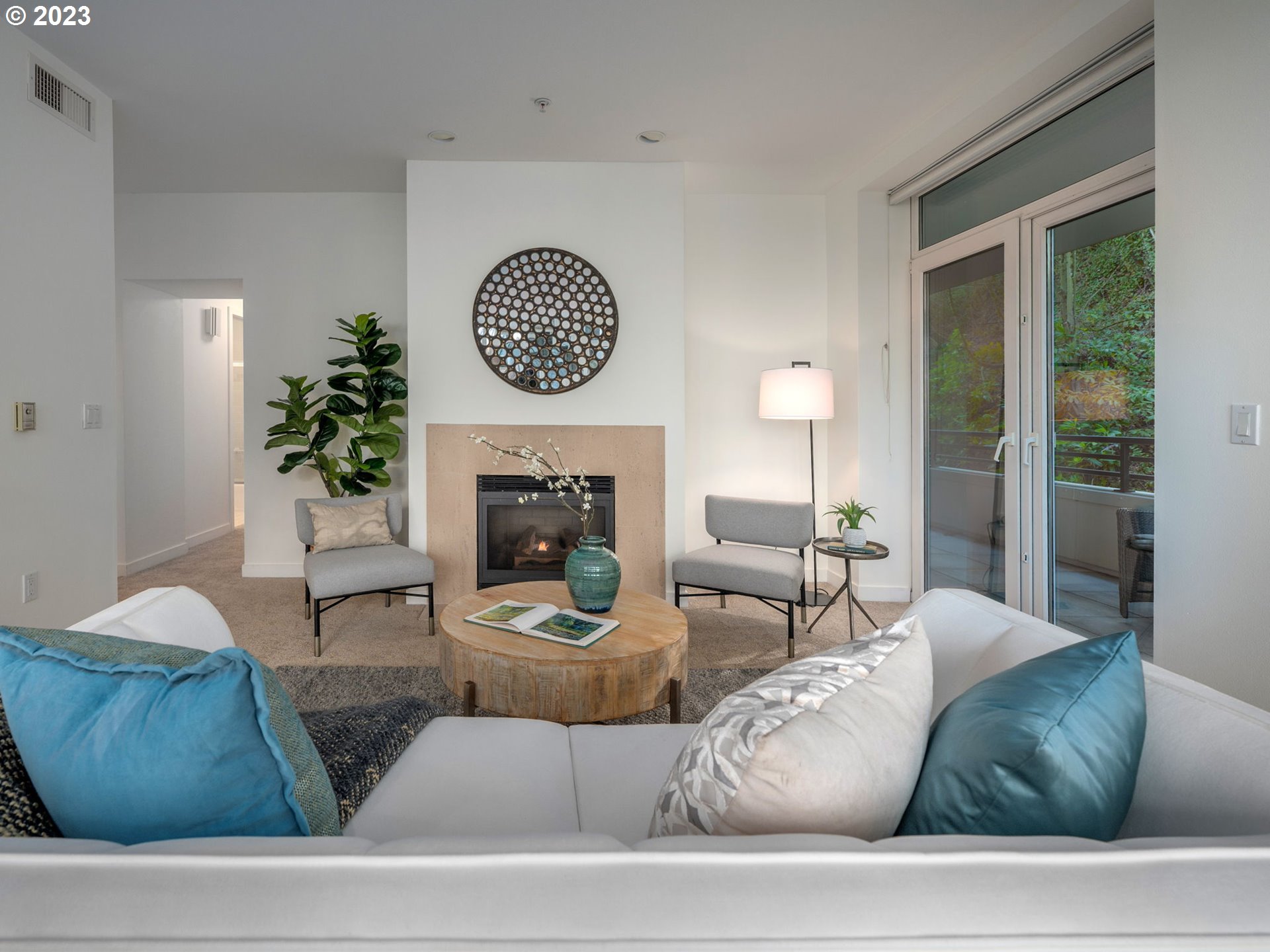 2445 Northwest Westover Road, Unit 314 Portland, OR 97210 - Photo 4 of 32 a living room with furniture a window and a fireplace
